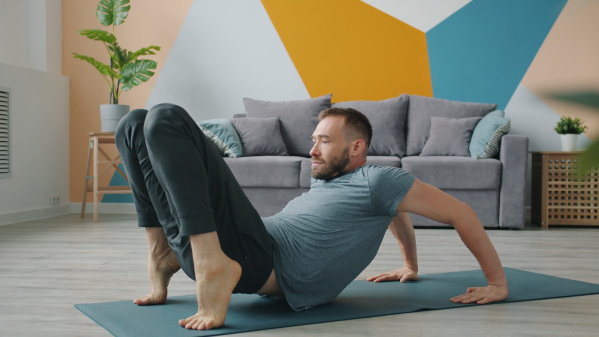 Man practicing pelvic floor exercises at home